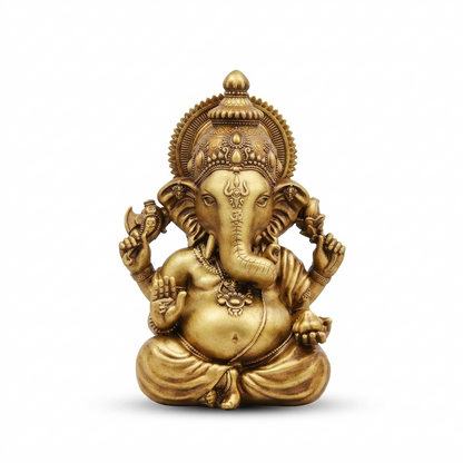 Ganesh idol in antique gold, seated with one hand raised in blessing, on a plain white background