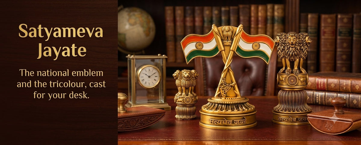 Ashok Stambh and crossed Indian tricolour flags on a desk. Text reads: Satyameva Jayate, the national emblem and the tricolour, cast for your desk.